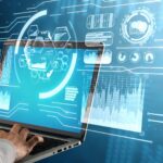 Hands using a laptop with data analysis and technology graphics.