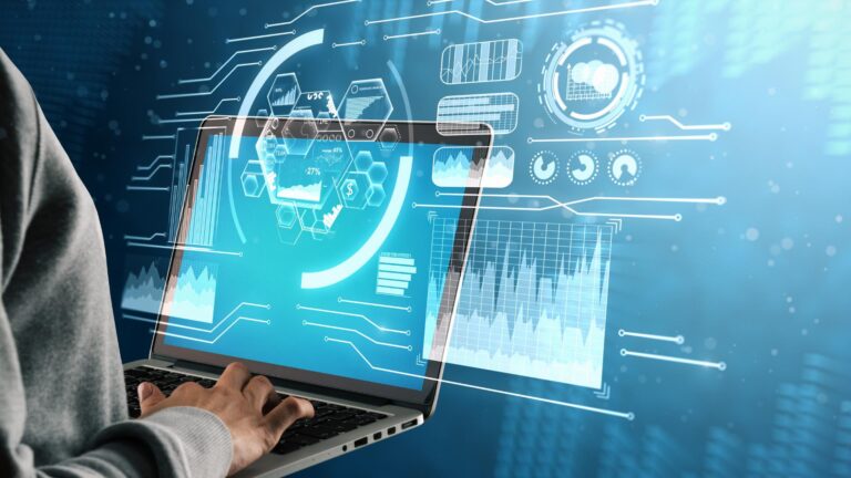 Hands using a laptop with data analysis and technology graphics.