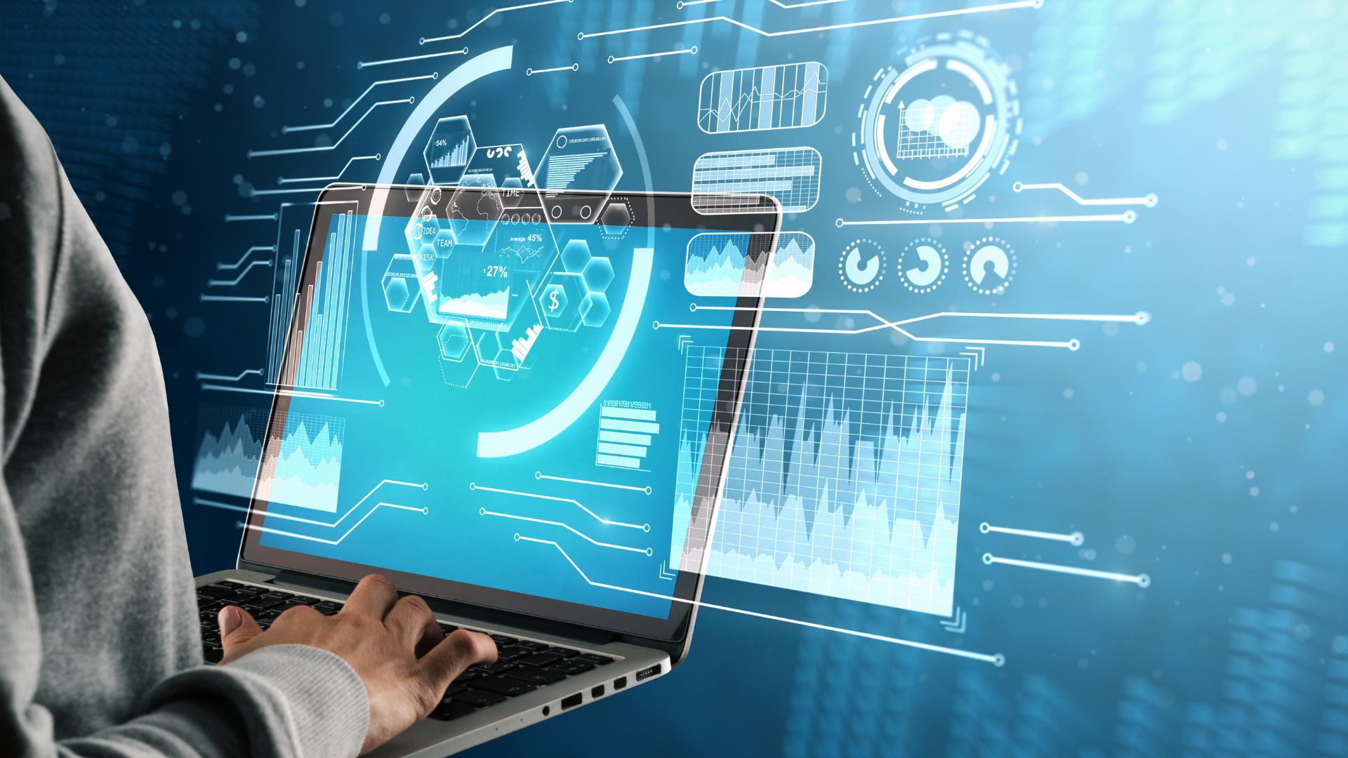 Hands using a laptop with data analysis and technology graphics.